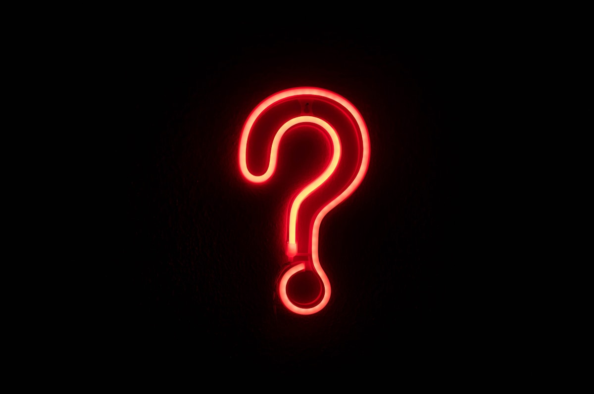 Think Fanny mystery riddle neon question mark on a dark wall